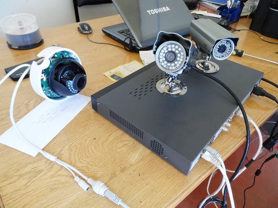 laptop and cctv cameras open on a desk